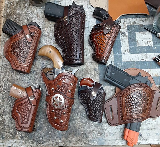 a grouping of hand tooled gun holsters