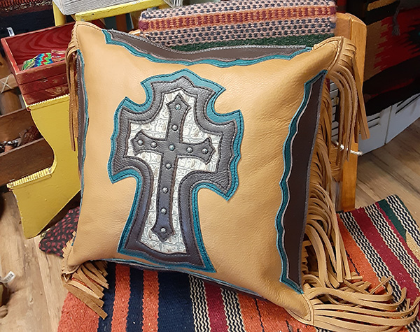a leather pillow with cross